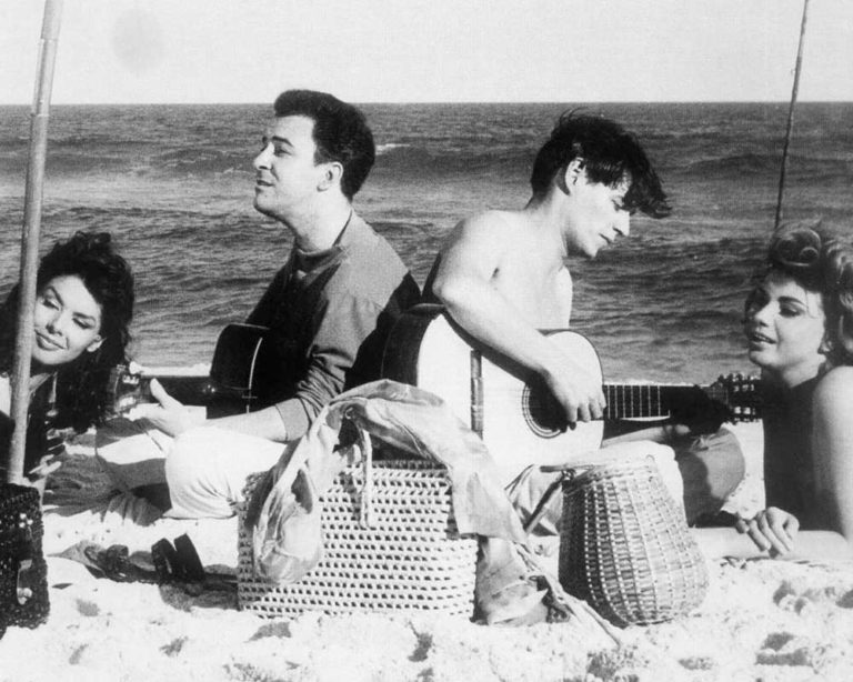 Joao Gilberto and Antonio Carlos Jobim with a pair of French actresses., Ipanema beach , RIo de Janeiro