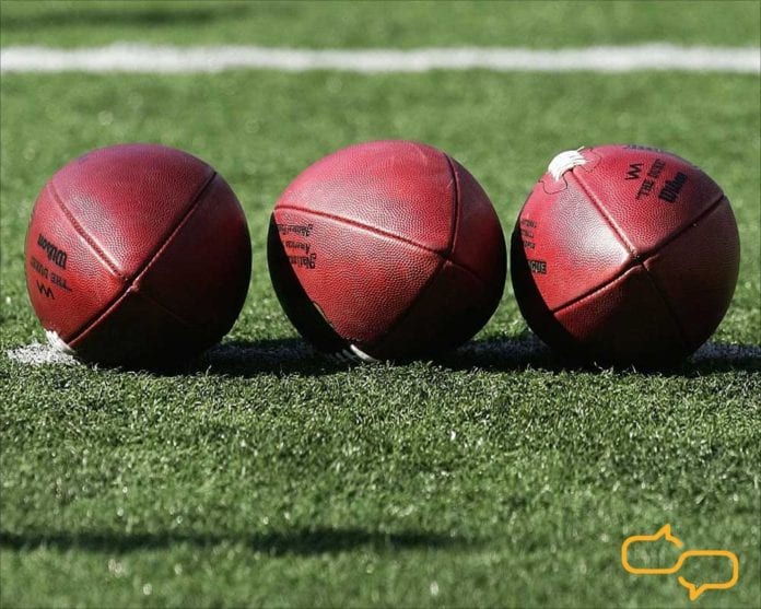Football Brasileiro - Three footballs lined up on grass field.