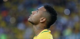 Brazilian footballer Neimeyer looks upwards during game.