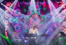 10 Questions With Ricardo Bacelar musician with keyboard amd colorful background with lights