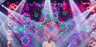 musician with keyboard amd colorful background with lights