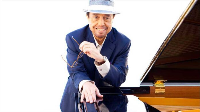 The Sounds of Brazil’s meet and greet with Sergio Mendes, pictured next to his grand piano.
