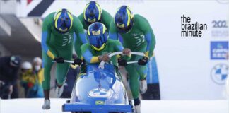 four people push a blue color3d bobseld at the winter olympic games