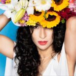 A New Song from Marisa Monte, pictured wearing sunflowers on her head.
