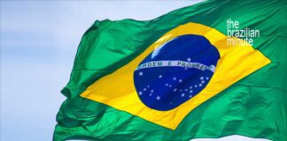 Brazil's National Flag waving in a clear blue sky.