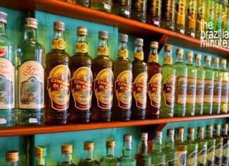 Brazil’s Cachaça Explained Brazilian Cachaça Explained: Dozens of cachaça bottles from various distillers line the wooden shelves, side by side.