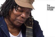 Milton Nascimento's Milestone Year. Nascimento wears his trademak tan cap while holding his guitar.