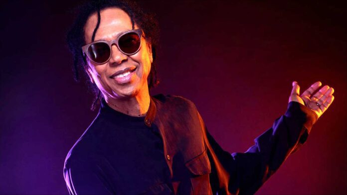 January's Brazilian Music Birthdays. Singer Djavan poses in dark long slves shirt and sunglasses.
