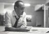 Understanding Brazilian Architect Oscar Niemeyer. A blacka nd white picute shows him at his design table.