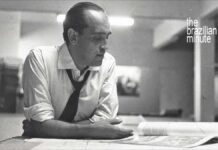 Understanding Brazilian Architect Oscar Niemeyer. A blacka nd white picute shows him at his design table.