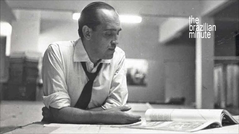 Understanding Brazilian Architect Oscar Niemeyer. A blacka nd white picute shows him at his design table.