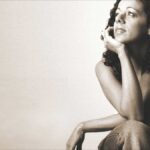 Relaxing Brazilian Music Streaming Channels: Brazilian woman sitting in a casual and calming pose.