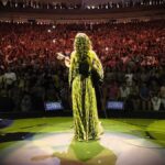 March salutes Brazils women of song, including singer Marisa Monte who faces the audience while performing.