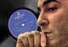 A world without Bossa Nova. Brazilian singer Joao Gilberto in profile with his debut record album in the background