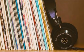 12 Influential Brazilian Jazz Albums Record collection of 12 Influential Brazilian Jazz Albums on a wood shelf with black headphones leansing against them.