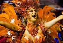Connect Brazil's Carnaval Coast-to-Coast guide gathers up the best - and most exciting - events. A Samba dancer in Orange feather ans red headdress celebrates at Carnaval in Brazil.